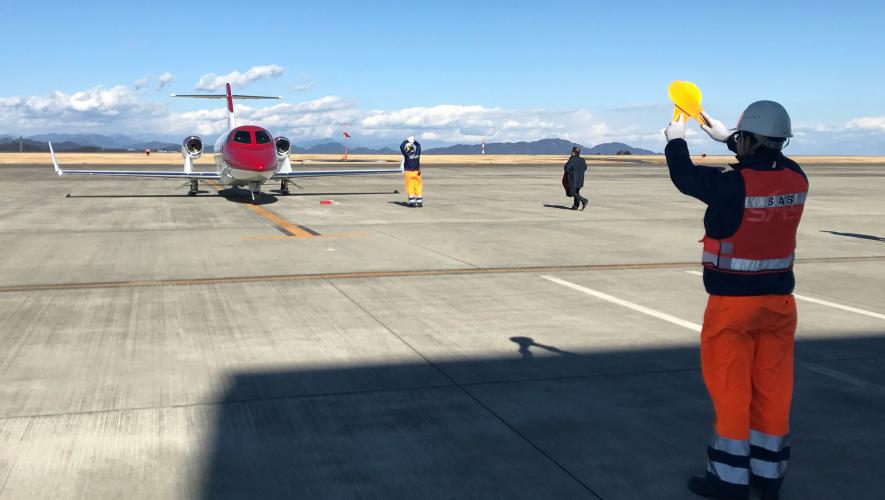 Marshaling business jet on ramp at Tokyo Haneda Airport